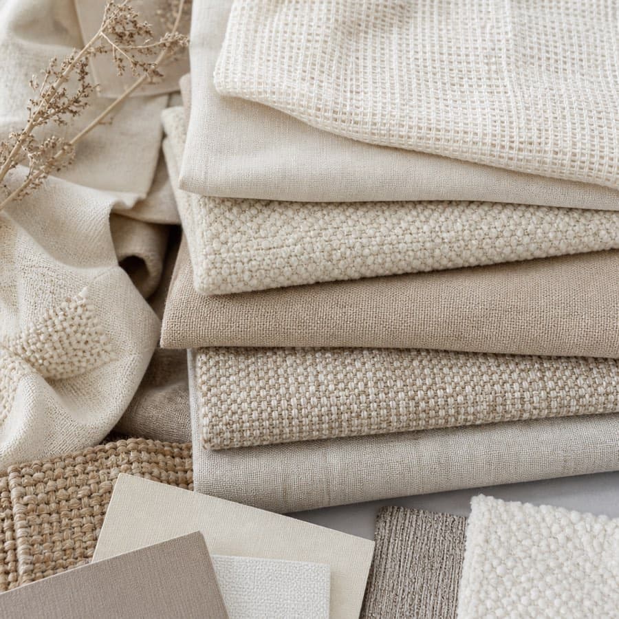 Natural fabric swatches arranged on a table